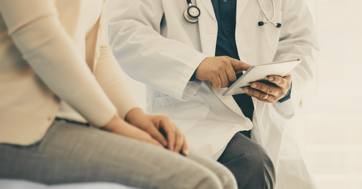 An image showing a patient speaking with a doctor in an office, discussing a treatment plan.